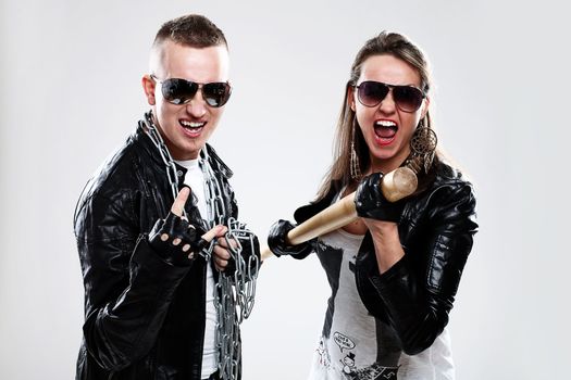 Young brutal couple in leather and sunglasses in studio