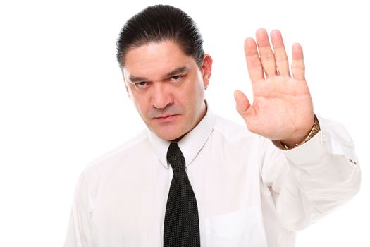 Serious mid aged businessman showing stop gesture over a white background