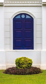 Arch Blue Window of Building with Small Garden