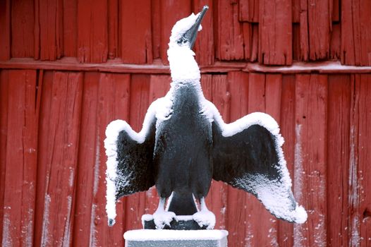 Oslo, Norway - Desember 2007. Bronze sculpture of a bird in snowfall