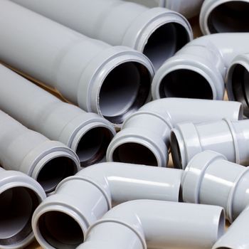Grey PVC sewer pipes background