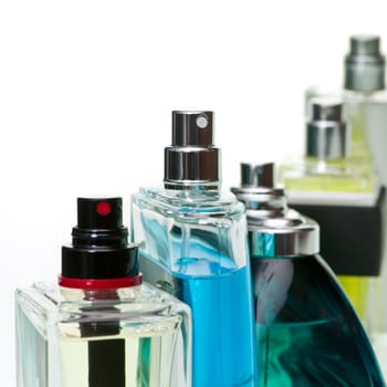 Assorted perfume bottles on white background, selected focus