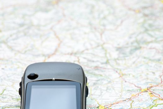 Hand-held GPS navigator on a map