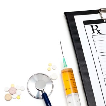 Pills syringe stethoscope and clipboard with Rx on white background