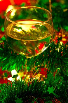 Glass of white wine with Christmas decoration, very shallow DOF