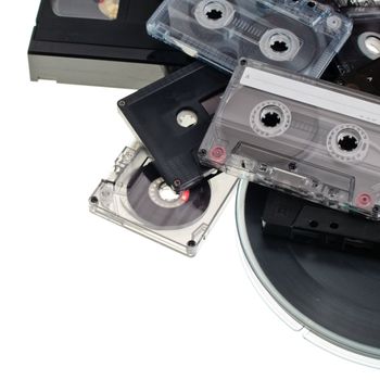 Heap of various vintage audio and video cassettes on white background