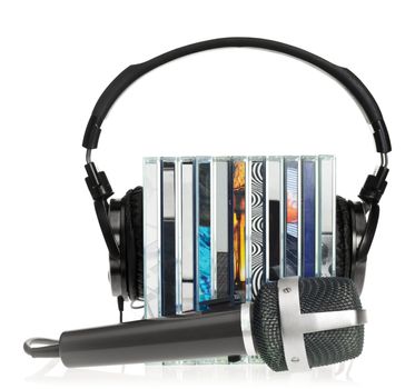 HI-Fi headphones on stack of CDs with microphone on white background