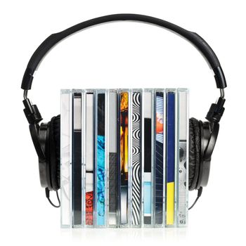 HI-Fi headphones on stack of CDs on white background
