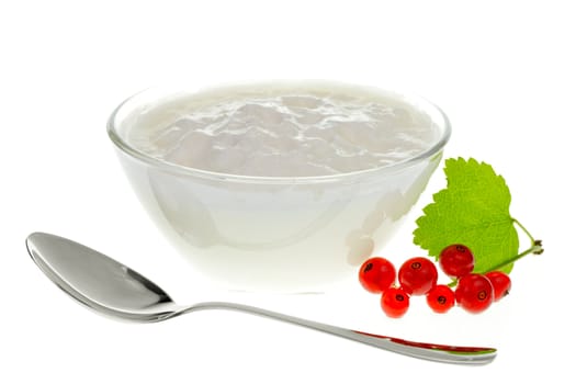 Yogurt bowl with spoon and Redcurrant berries on white background