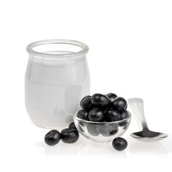 Yogurt jar blueberries and spoon on white background
