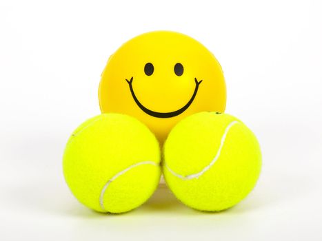 smiling tennis ball and two normal balls