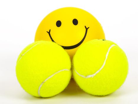 smiling tennis ball and two other balls
