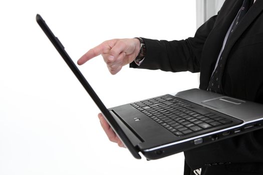 Male hand pointing to computer screen