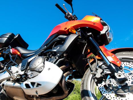 orange sport bike on a blue sky