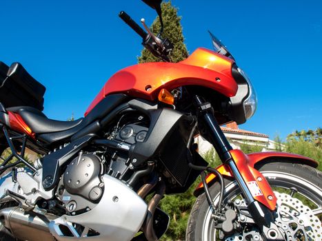 orange sport motorbike and blue sky