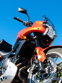 orange motorbike and a blue sky