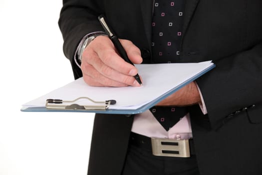 businessman holding a notepad and writing