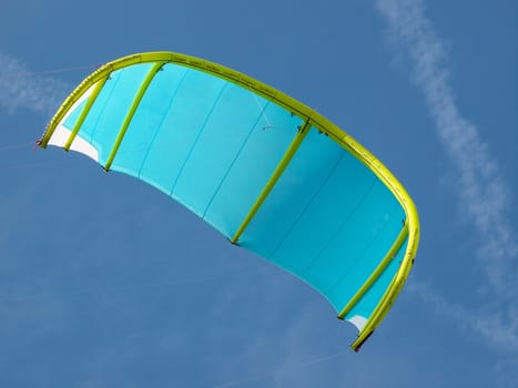 blue and green kite for kitesurfing in the sky