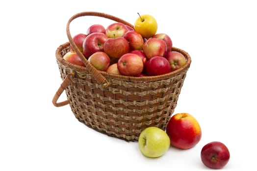 Ripe apples in a basket on a white background