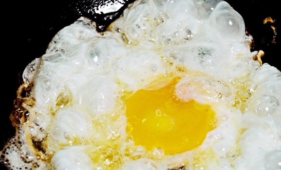 Native Thai style fried egg in hot pan
