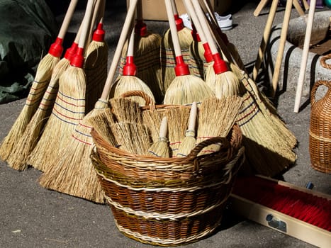 big and small brooms in the basket