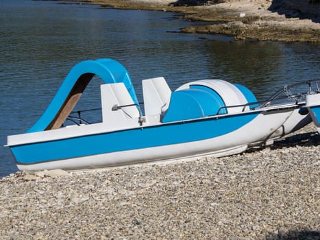 pedal boat on the stone beach