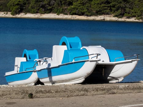 two pedal boats on the beach