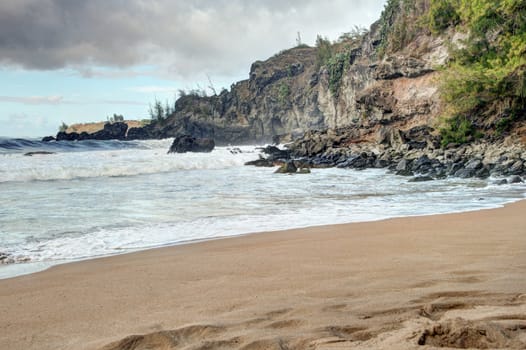 Rocky Maui shoreline with slow moving waves