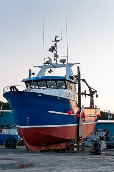 Fish trawler on land during off peak season, ship goes through maintenance