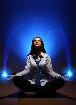 Young business woman sitting in asana lotus and meditating