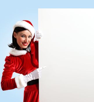 Portrait of a santa girl with a blank banner