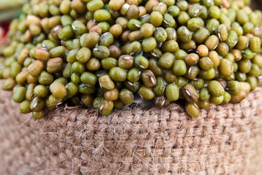 green mung bean on sack isolated in white background