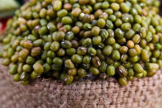 green mung bean on sack isolated in white background