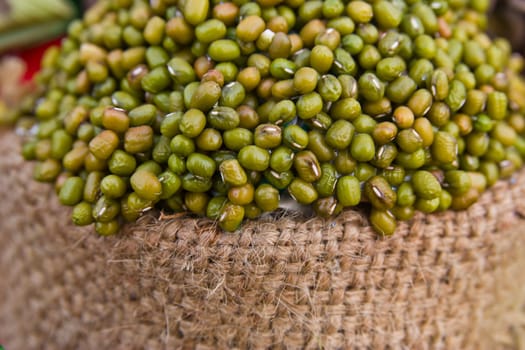 green mung bean on sack isolated in white background