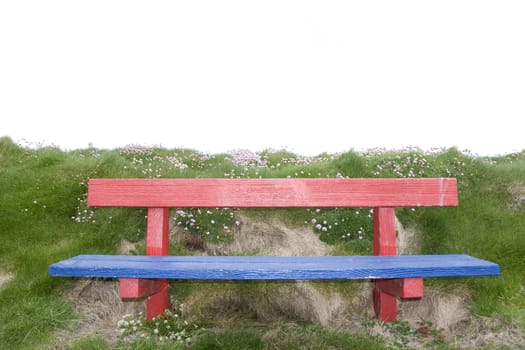 red and blue bench positioned at the edge on top of a cliff