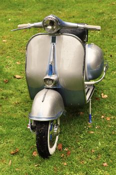 Vintage scooter on the lawn after the rain