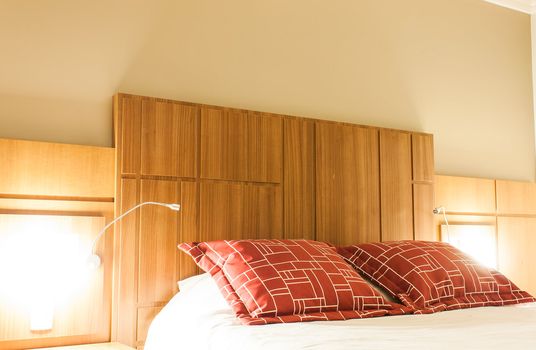 A design red pillow in a modern style bedroom