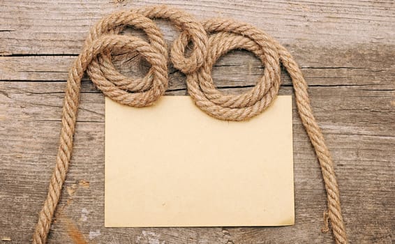 parchment paper and ship ropes on wood 