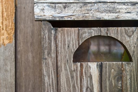 Vintage grungy letter box on wooden door