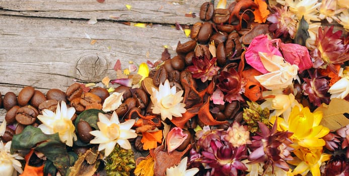 straw flower background with coffee beans over wooden table