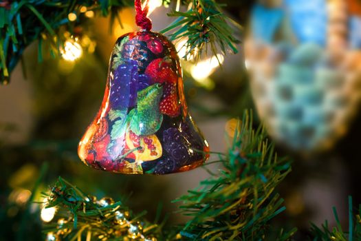 Christmas Bell ornamented with fruits on a Christmas Tree