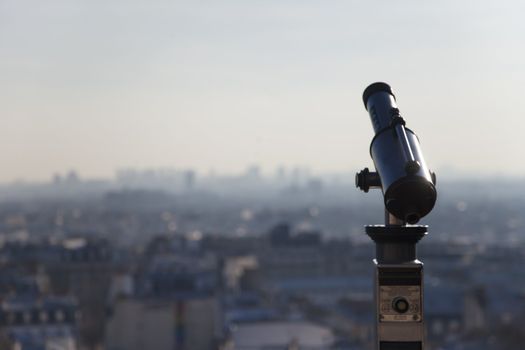 Telescope on top of Montmartre Paris with the city on the background