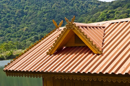 thai house roof an nice blue sky