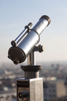 Telescope on top of Montmartre Paris with the city on the background