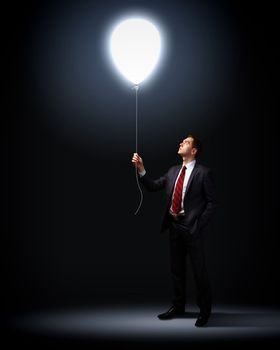 Light bulb and a business person as symbols of creativity in business