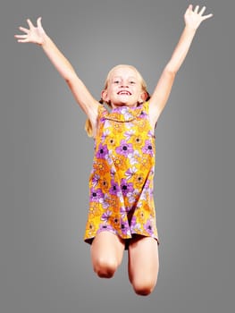 girl jumping hands up, happy and smiling