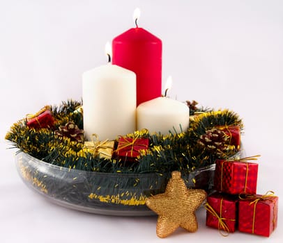 Christmas decorations and candles on a light background