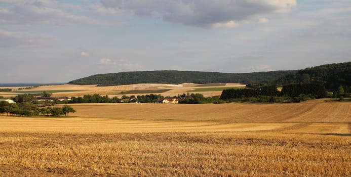 Panorama of northern French countryside and harvested wheat fields
