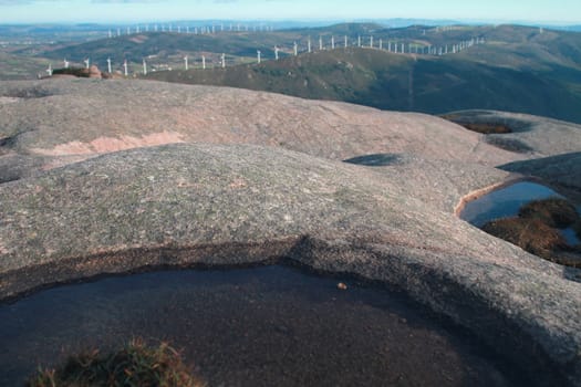 Peak of Mount Pindo, with view of an eolic park, Spain
