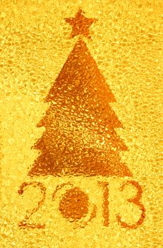 Closeup shot of Christmas tree crystal golden background